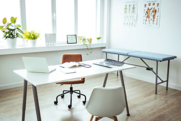 istock Interior of empty pediatrician office with bed and computer. 1428280526