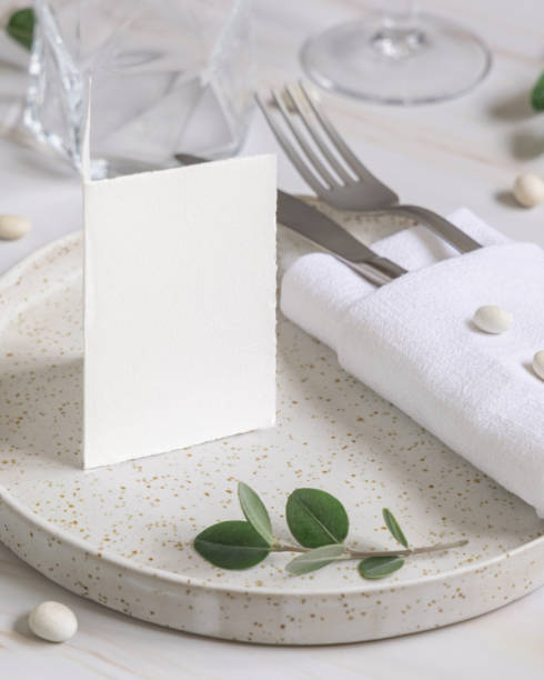 istock Table setting with folded card decorated with eucalyptus branches close up, Wedding mockup 1428281071