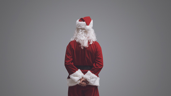 Santa Claus standing and looking away, back view, Christmas and holidays concept