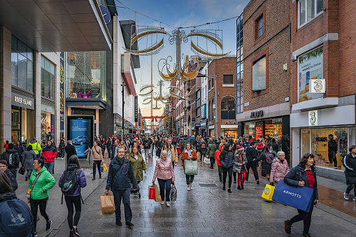 Dublin, November 2019 Henry Street decorated for Christmas with crowds of people on shopping spree. The Spire on OConnell street visible in background