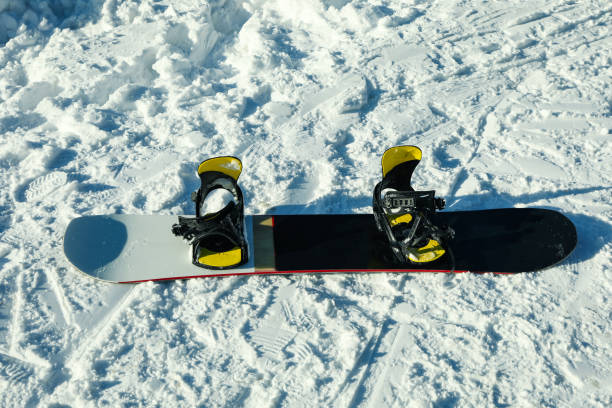 istock Empty snowboard on snow in sunny day 1428285641