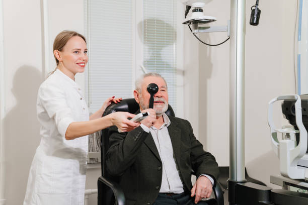 istock ophthalmologist diagnoses elderly man's vision on a sign projector. 1428286957