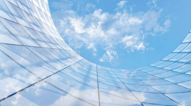 Abstract architecture with large glass surfaces reflecting the blue sky