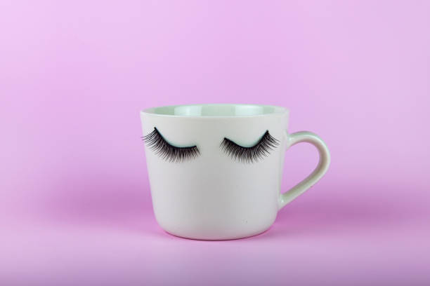 istock Funny white mug with eyes on a pink background. 1428287697