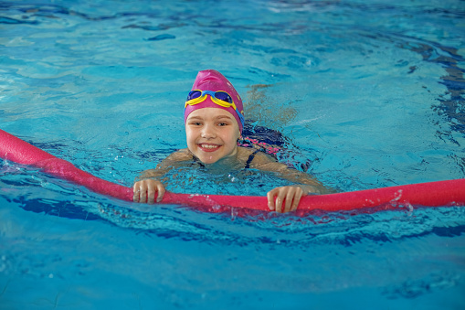 Foam stick for swimming. Sports healthy lifestyle. Swimming lessons at school.