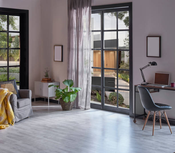 istock Modern rom with working table and armchair style, parquet floor, frame lamp decor, curtain, garden view house interior. 1428289961