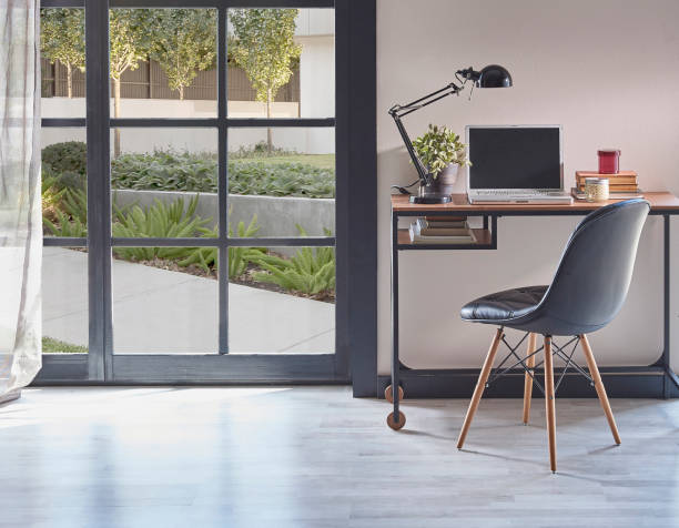 istock Modern rom with working table and armchair style, parquet floor, frame lamp decor, curtain, garden view house interior. 1428291853