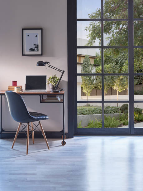istock Modern rom with working table and armchair style, parquet floor, frame lamp decor, curtain, garden view house interior. 1428292321