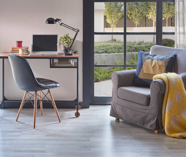 istock Modern rom with working table and armchair style, parquet floor, frame lamp decor, curtain, garden view house interior. 1428293009