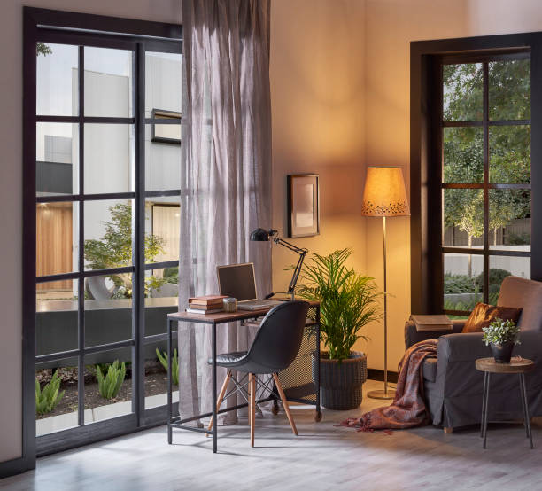 istock Modern rom with working table and armchair style, parquet floor, frame lamp decor, curtain, garden view house interior. 1428293032