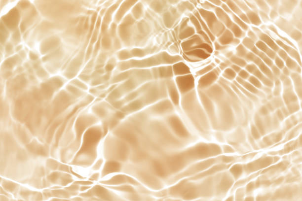 イエローオレンジウォーターウェーブ、自然な渦巻きパターンテクスチャの背景、抽象的な写真