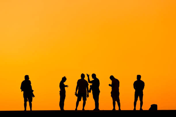 istock Silhouette of some photographer people on sunset. 1428298565