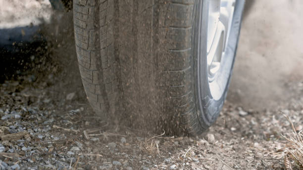 istock Dust splashing from tire of car driving 1428298624