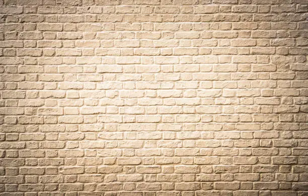 Photo of Off white painted large brick wall surface