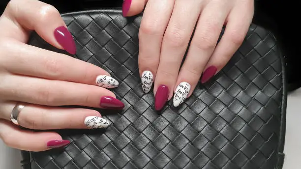 Manicure and nail extension with acrylic and gel. The design is made with reflective gel polishes. Beauty and fashion.