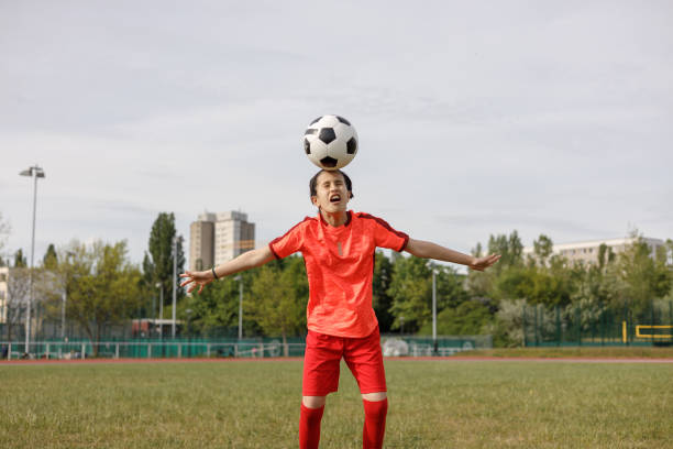 Girl heading the soccer ball
