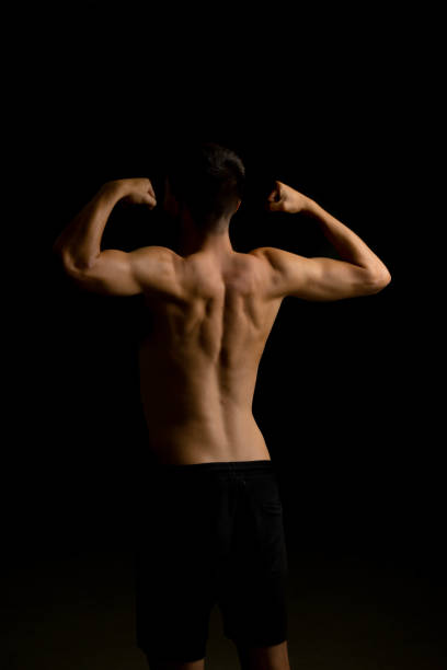 istock Nineteen year old teen boy flexing his back 1428316056