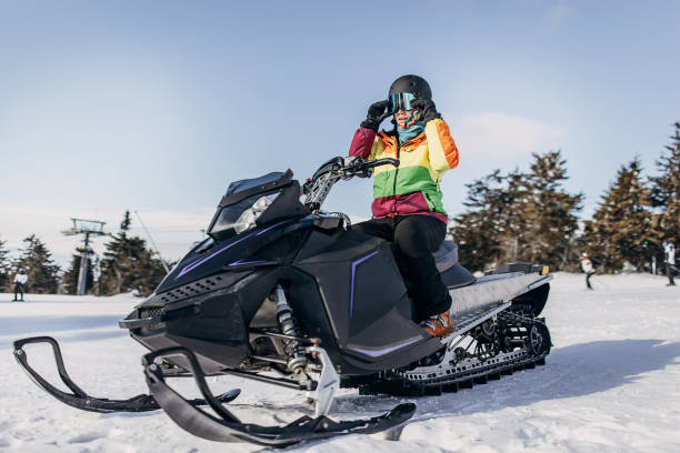 женщина, сидящая на снегоходе - snowmobiling adventure snow travel стоковые фото и изображения