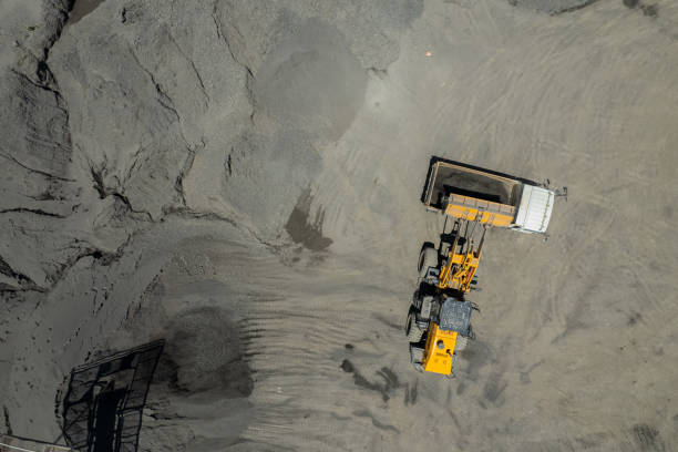 istock Sand loaders are shoveling rocks into dump trucks. 1428318819