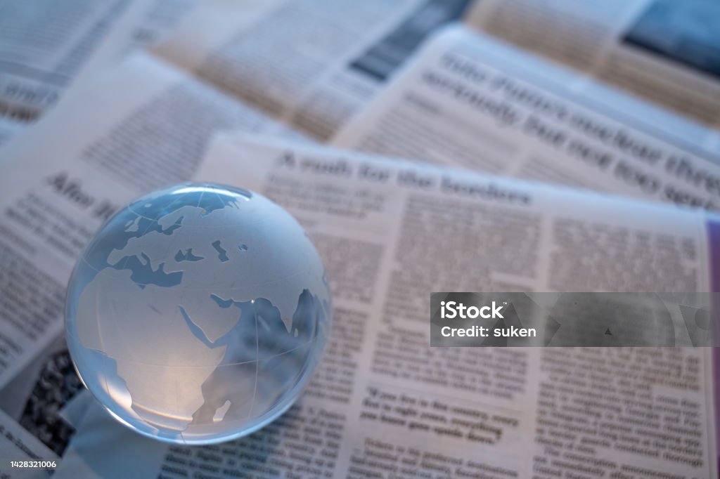 glass globe on newspapers Newspaper Stock Photo
