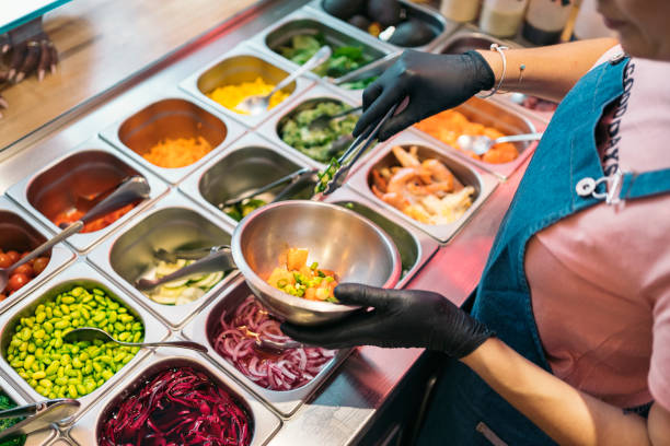 istock Woman Adding Ingredients Into Poke Bowl 1428326103
