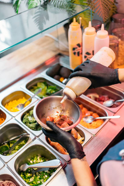 istock Adding Sauce to Poke Bowl 1428326157
