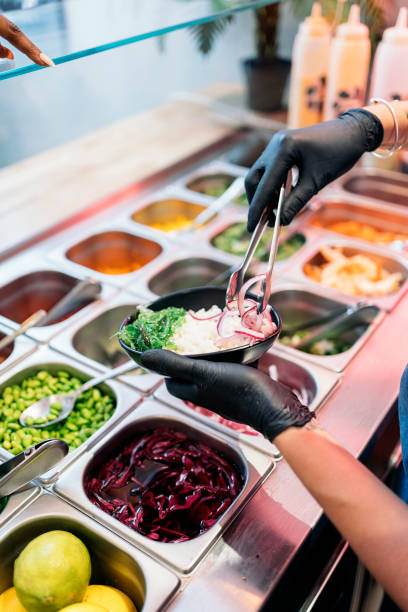 istock Adding Sauce to Poke Bowl 1428327239