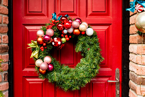Waiting for Christmas - Red Wooden Front Door Decorated with Wreath, Garlands, Dwarfs, Gifts,...