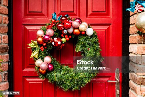 istock Waiting for Christmas - Red Wooden Front Door Decorated with Wreath, Garlands, Dwarfs, Gifts,... 1428327919
