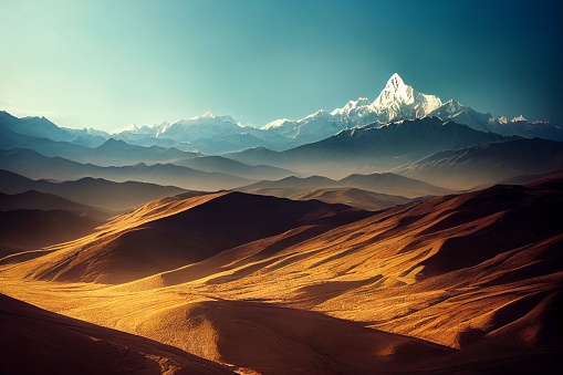 The sand dunes before the snowy mountains under the blue sky in Tibet