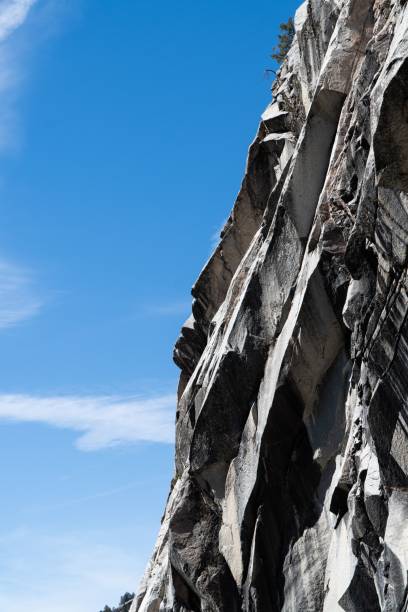 istock Vertical low-angle view of a rocky cliff under the blue sky on a sunny day 1428342752