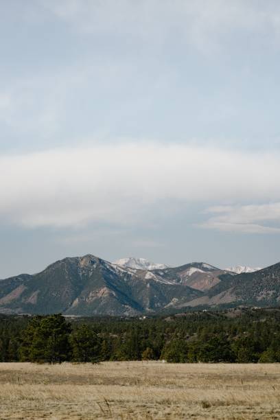 istock Vertical shot of tall mountains under a cloudy sky 1428350154
