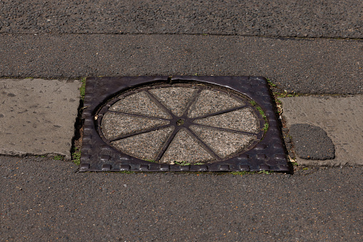 Old manhole cover in a road