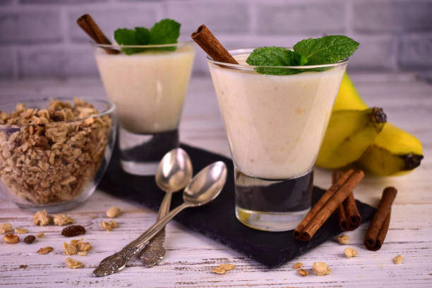 istock Banana yogurt with cinnamon and granola in glasses. 1428357064