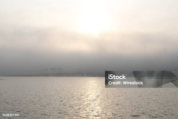 Reflection Of The Sun In The Sea Behind Sunrise Clouds On A Fogg Day Stock Photo - Download Image Now