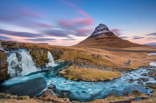 A breathtaking landscape with waterfall near Kirkjufellsfoss and Kirkjufell hills in Iceland