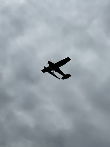 istock Vertical shot of a plane in flight in the cloudy sky 1428360867