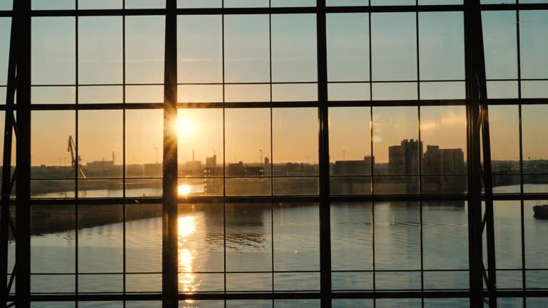 Bright sunrise behind the glass windows of an office building