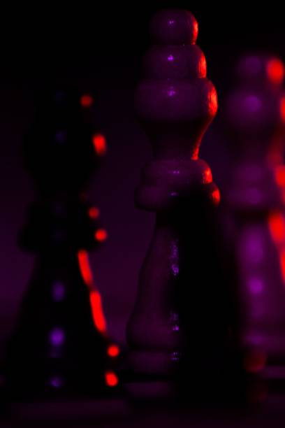 istock Vertical shot of chess pieces in a purple light 1428362104