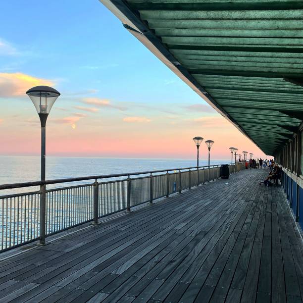 istock Wooden deck on the coast with a cloudy sunset sky in the background 1428362979