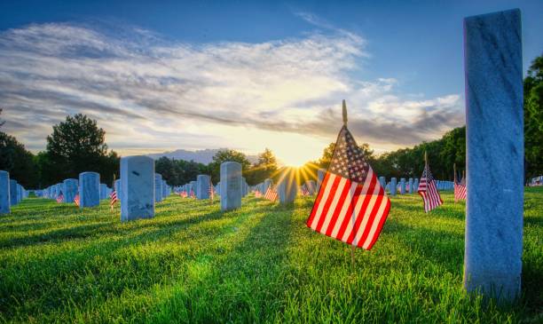 istock American flags placed by gravestones in Fort Logan cemetery 1428363362