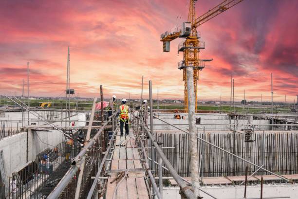 istock Closeup shot of construction workers on a pink sunset background 1428363380