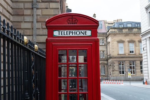 A view of a telephone red box on a street