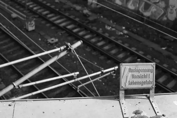 A monochrome shot of the Hamburg HBF transit section in Hamburg Germany with a warning sign