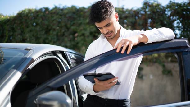 istock Car dealer with digital tablet 1428372478