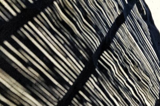 istock Texture background of shadow lines on the sand 1428374193