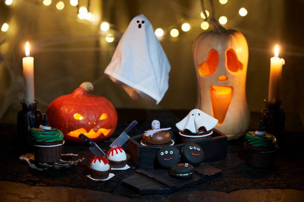 istock Halloween pumpkin with burning mouths, candles, drinks and sweets. 1428375017