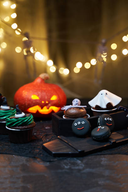 istock Halloween pumpkin with burning mouths, candles, drinks and sweets. 1428375307