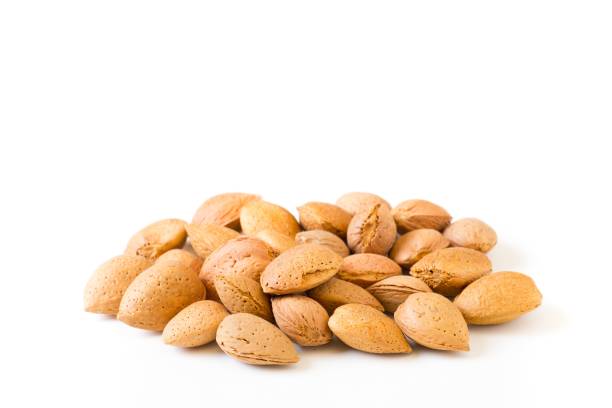 istock Pile of almonds on a white background 1428376828