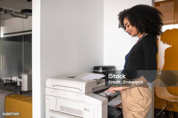 Woman Standing Near The Xerox In The Office Stock Photo - Download Image Now - Computer Printer, Office, Young Adult